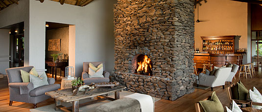 Main Lodge Bar area with lounge and fireplace at Lion Sands Narina Lodge in the Big 5 Sabi Sand Private Game Reserve, South Africa